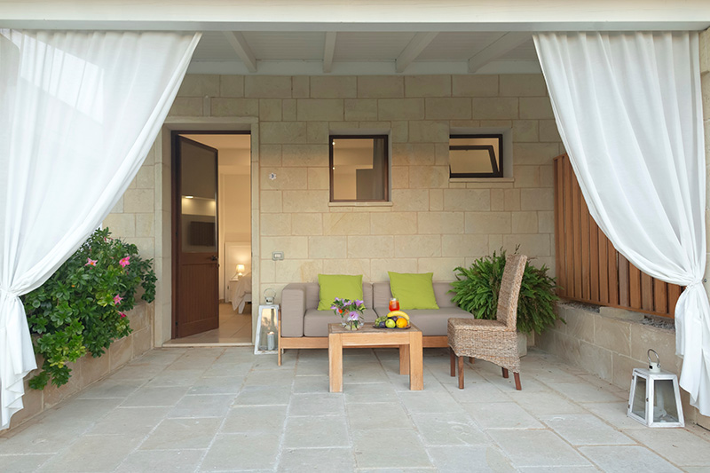 The,Outdoor,Seating,Area,Boasts,A,Cozy,Couch,,A,Stylish